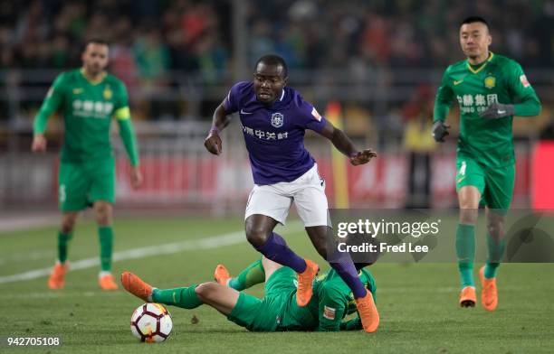 Frank Acheampong of Tianjin Teda FC and Chi Zhongguo of Beijing Guoan in action during the 2018 Chinese Super League match between Beijing Guoan and...