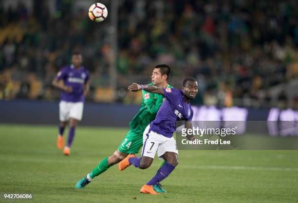 Frank Acheampong of Tianjin Teda FC and Zhang yu of Beijing Guoan in action during the 2018 Chinese Super League match between Beijing Guoan and...