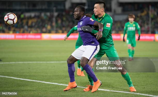 Frank Acheampong of Tianjin Teda FC and Li Lei of Beijing Guoan in action during the 2018 Chinese Super League match between Beijing Guoan and...