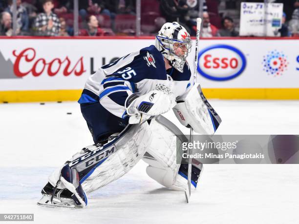 Goaltender Steve Mason of the Winnipeg Jets protects his net during the warm-up prior to the NHL game against the Montreal Canadiens at the Bell...