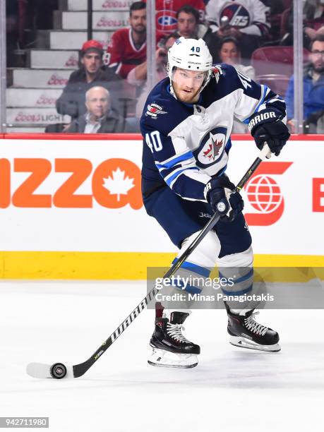 Joel Armia of the Winnipeg Jets looks to play the puck against the Montreal Canadiens during the NHL game at the Bell Centre on April 3, 2018 in...