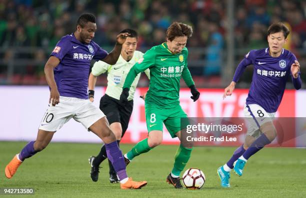 John Obi Mikel , Li yuanyi of Tianjin Teda and Piao Cheng of Beijing Guoan in action during the 2018 Chinese Super League match between Beijing Guoan...