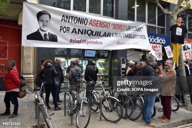 Workers of the newspaper of 'El Periodico' seen holding a banner with the photo of Antonio Asensio Mosbah, President of Editorial Z Group during the...