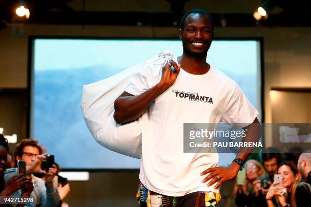 Member of 'Sindicato Popular de Vendedores Ambulantes' walks the catwalk during a fashion show to present the t-shirts of their new crowdfunded...