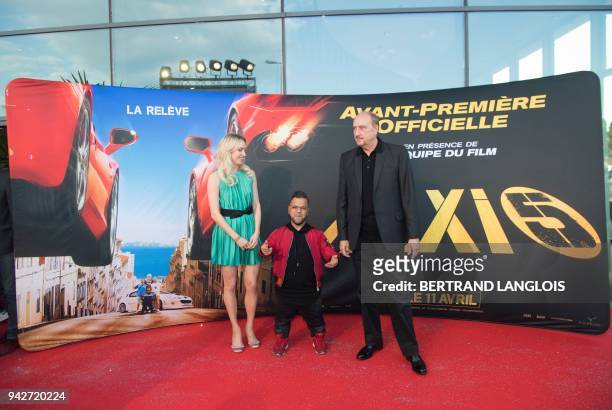 French actress Sand Van Roy, French actor Anouar Toubali and French actor Bernard Farcy pose during a photocall for the premiere of the film "Taxi 5"...