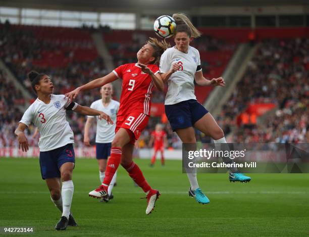 Abbie McManus of England and Kayleigh Green of Wales challenge for the ball as Demi Stokes of England looks on during the Women's World Cup Qualifier...