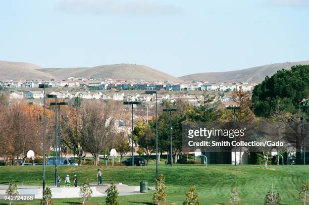People use a skatepark at Emerald Glen park, with new housing visible in the background, a public park in the rapidly-developing San Francisco Bay...