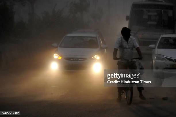 Commuters face problem as city experienced dust storm and rainfall in the evening hours on April 6, 2018 in Noida, India.