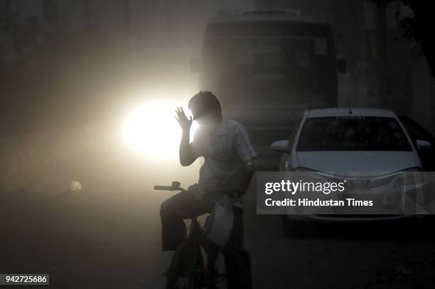 Commuters face problem as city experienced a dust storm and rainfall in the evening hours on April 6, 2018 in Noida, India.