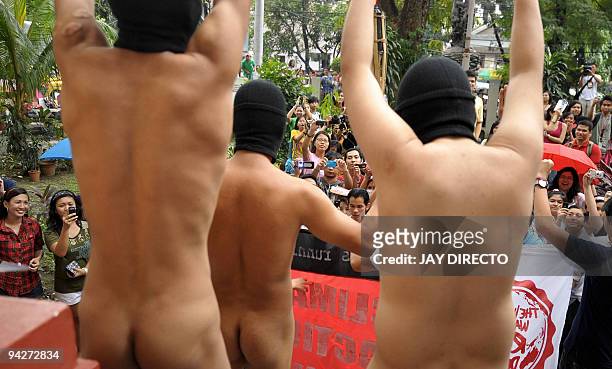 Several dozen male students holding roses and "climate change" banners run naked at the state-run University of the Philippines in Manila on December...