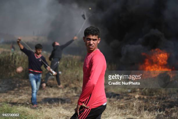 Palestinian protestors gesture during clashes with Israeli security forces on the Gaza-Israel border following a protest calling for the right to...