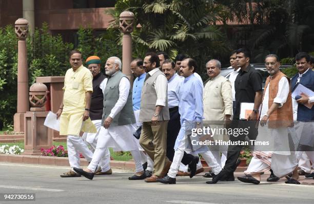 Prime Minister Narendra Modi with senior BJP leaders and Union Ministers after BJP Parliamentary Party Meeting at Parliament House library on April...