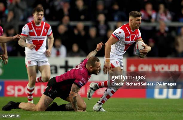 Saint Helens' Tom Makinson skips past by Hull FC's Josh Griffin during the Betfred Super League match at the Totally Wicked Stadium, St Helens.