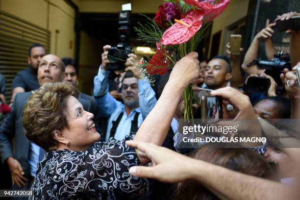 Brazilian former president Dilma Rousseff is greeted by supporters at the Minas Gerais' Electoral Regional Tribunal in Belo Horizonte, Brazil, where...