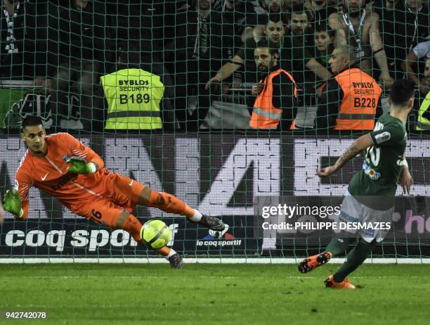 Paris Saint-Germain's French goalkeeper Alphonse Areola deflects a penalty kick shot by Saint-Etienne's French forward Remy Cabella during the French...