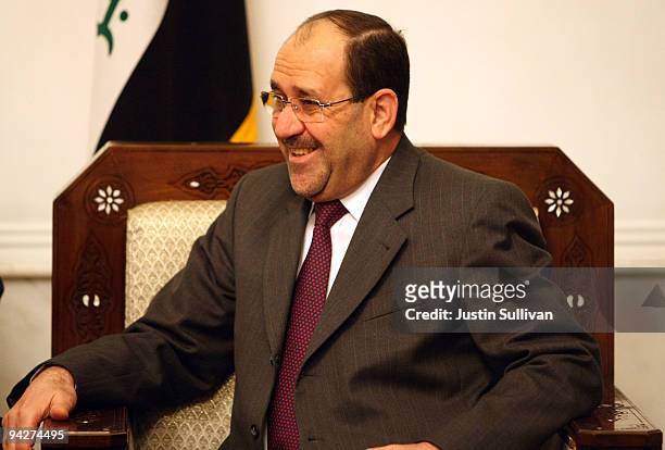 Iraqi Prime Minister Nouri Al-Maliki looks on as he meets with U.S. Secretary of Defense Robert Gates at his residence in the Green Zone December 11,...