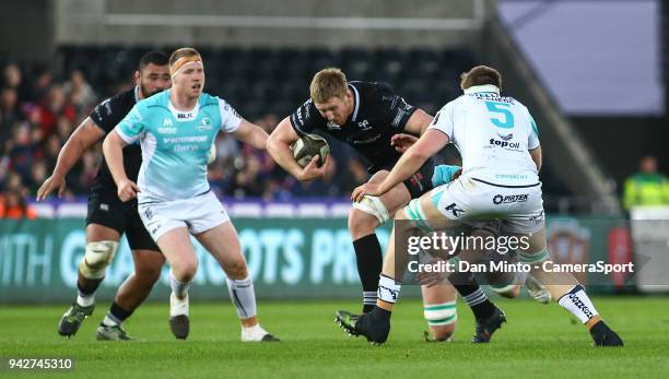 Ospreys' Bradley Davies looks to avoid the tackle of Connachts' James Cannon during the Guinness Pro14 Round 19 match between Ospreys and Connacht at...