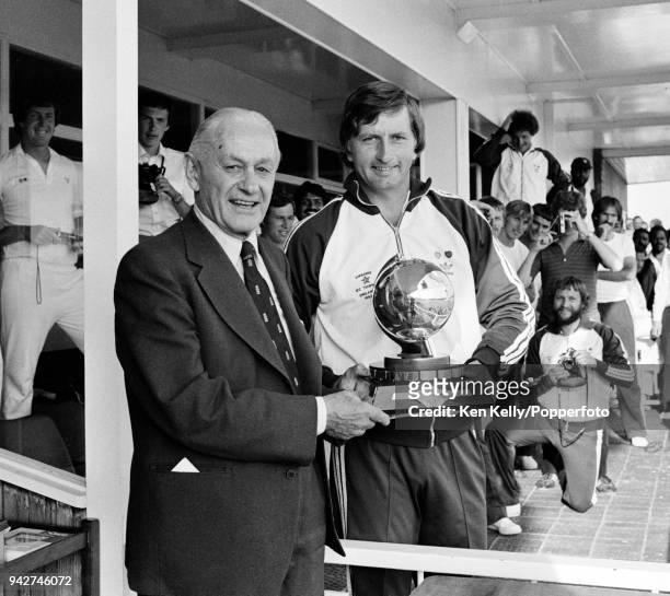 Zimbabwe captain Duncan Fletcher receives the International Cricket Council Trophy from Gubby Allen after their victory over Bermuda in the ICC...