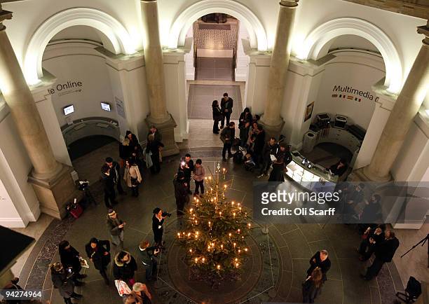 Members of the public view the 2009 Tate Britain Christmas Tree which was designed by artist Tacita Dean and is entitled 'Weihnachtsbaum' on December...