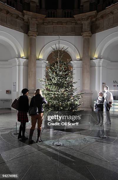 Members of the public view the 2009 Tate Britain Christmas Tree which was designed by artist Tacita Dean and is entitled 'Weihnachtsbaum' on December...