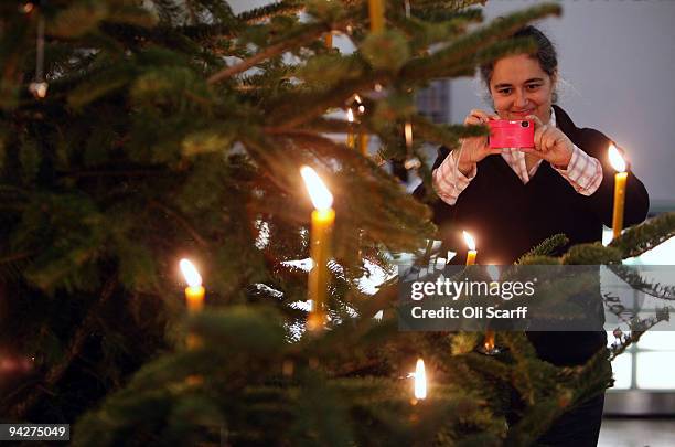 Artist Tacita Dean takes a photograph of the 2009 Tate Britain Christmas Tree which she designed and titled 'Weihnachtsbaum' on December 10, 2009 in...