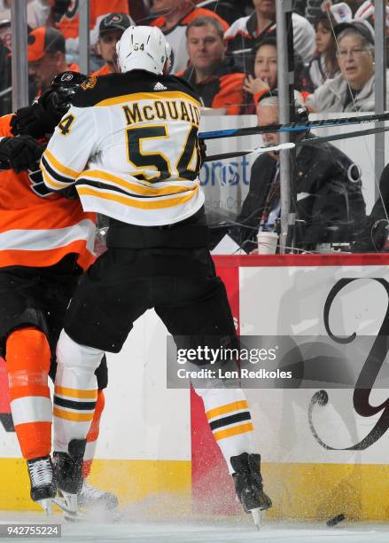 Adam McQuaid of the Boston Bruins battles for the puck along the boards against a member of the Philadelphia Flyers on April 1, 2018 at the Wells...