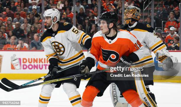 Nolan Patrick of the Philadelphia Flyers positions himself on a scoring opportunity against Adam McQuaid and Anton Khudobin of the Boston Bruins on...