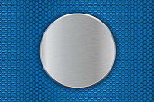 Metal round plate on blue perforated background