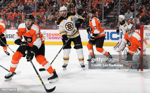 Brandon Manning, Andrew MacDonald and Petr Mrazek of the Philadelphia Flyers defend Patrice Bergeron and Matt Grzelcyk of the Boston Bruins on April...