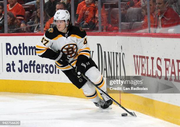 Torey Krug of the Boston Bruins skates the puck against the Philadelphia Flyers on April 1, 2018 at the Wells Fargo Center in Philadelphia,...