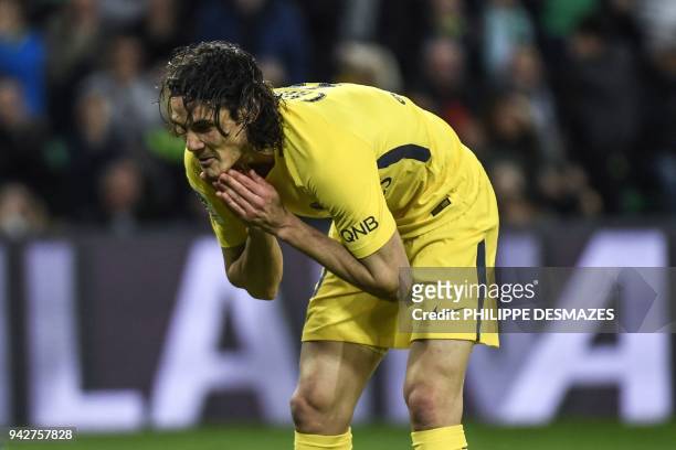 Paris Saint-Germain's Uruguayan forward Edinson Cavani reacts after missing a shot during the French L1 football match between AS Saint-Etienne and...