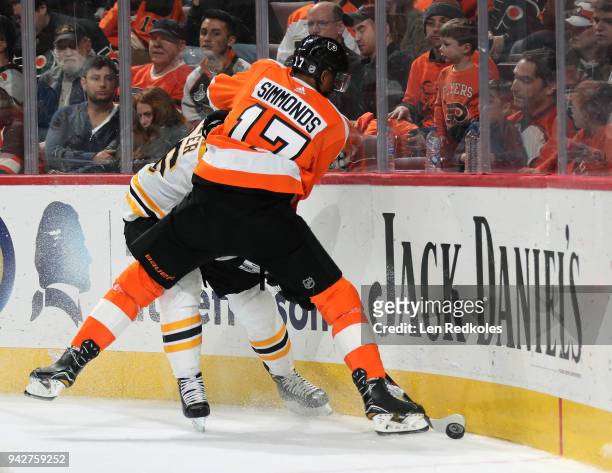 Wayne Simmonds of the Philadelphia Flyers battles for the puck in the corner against Kevan Miller of the Boston Bruins on April 1, 2018 at the Wells...