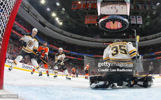 Anton Khudobin of the Boston Bruins stops a shot on goal with teammates Zdeno Chara and Patrice Bergeron against Sean Couturier of the Philadelphia...