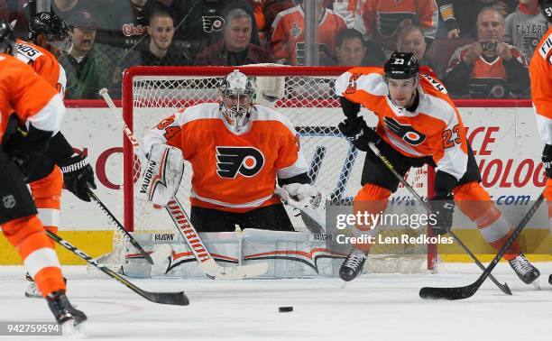 Brandon Manning, Petr Mrazek and Wayne Simmonds of the Philadelphia Flyers react to a shot on goal by the Boston Bruins on April 1, 2018 at the Wells...