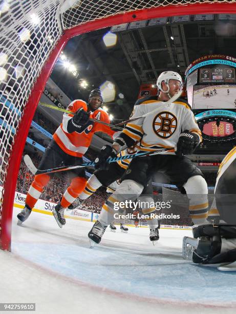 Wayne Simmonds of the Philadelphia Flyers backchecks Kevan Miller of the Boston Bruins on April 1, 2018 at the Wells Fargo Center in Philadelphia,...