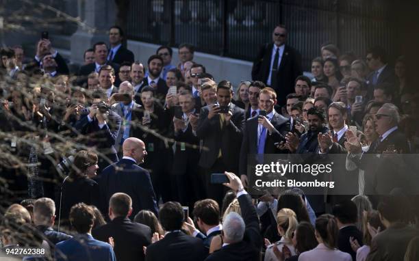 McMaster, outgoing national security advisor, center left, is greeted with applause while departing on his last day of work at the White House in...