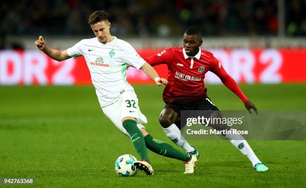 Ihlas Bebou of Hannover and Marco Friedl of Bremen battle for the ball during the Bundesliga match between Hannover 96 and SV Werder Bremen at...