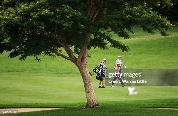 Raphel Cabrera Bello of Spain walks with David Drysdale of Scotland down the 15th fairway during the second round of the Alfred Dunhill Championship...