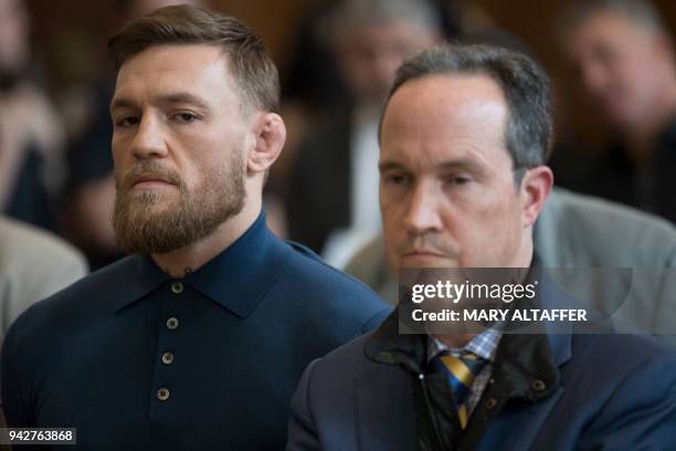 Irish Mixed Martial Arts fighter Conor McGregor stands with his lawyer Jim Walden during his arraignment at the Kings County Criminal Court on April...