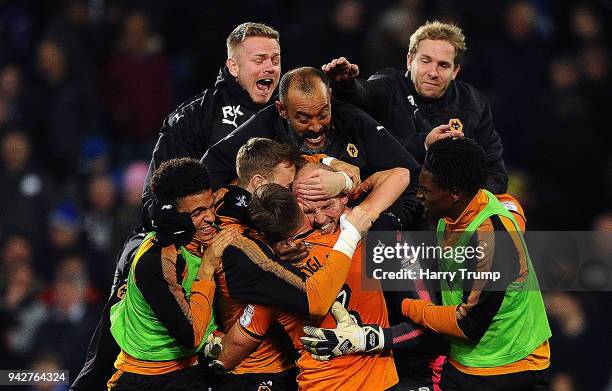 The players and Nuno Espirito Santo, Manager of Wolverhampton Wanderers celebrate with keeper John Ruddy of Wolverhampton Wanderers after he saves...