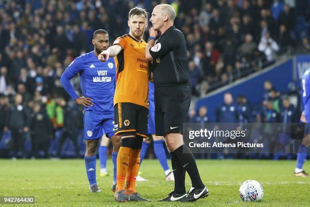 Leo Bonatini of Wolverhampton Wanderers argues with referee Mike Dean after the second penalty is award during the Sky Bet Championship match between...