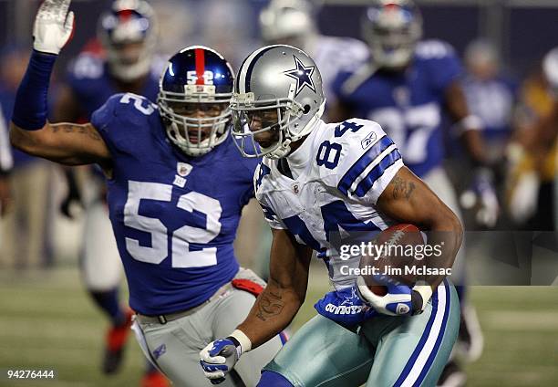 Patrick Crayton of the Dallas Cowboys runs the ball against Michael Boley of the New York Giants on December 6, 2009 at Giants Stadium in East...