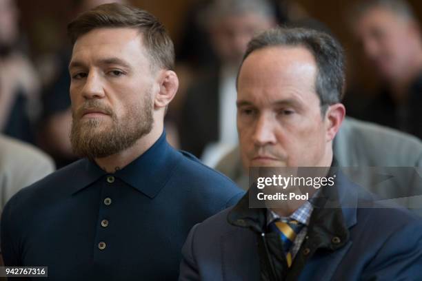 Ultimate fighting star Conor McGregor stands with his lawyer Jim Walden during an arraignment in Brooklyn Criminal court on April 6, 2018 in New York...