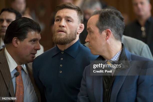 Ultimate fighting star Conor McGregor stands with his lawyer Jim Walden during an arraignment in Brooklyn Criminal court on April 6, 2018 in New York...