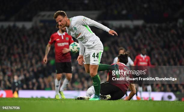 Philipp Bargfrede of Bremen is challenged by Miiko Albornoz of Hannover during the Bundesliga match between Hannover 96 and SV Werder Bremen at...