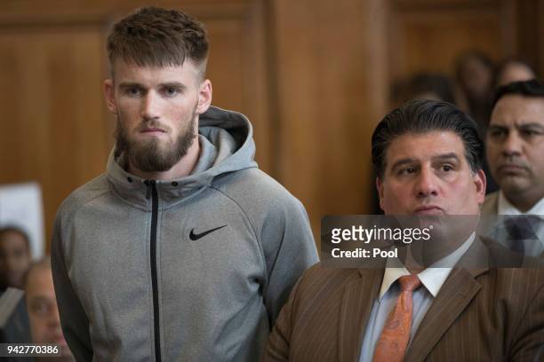 Mixed Martial Arts fighter Cian Cowley stands with lawyer John Arlia during an arraignment in Brooklyn Criminal court on April 6, 2018 in New York...