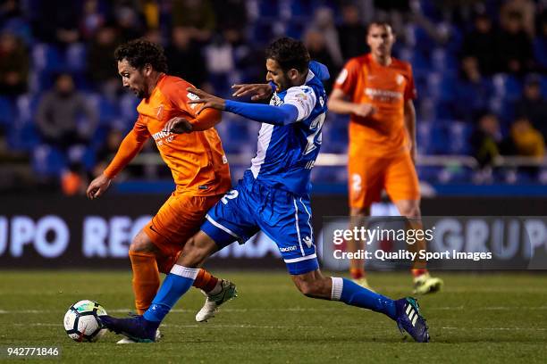 Celso Borges of Deportivo de La Coruna competes for the ball with Manuel Rolando Iturra of Malaga CF during the La Liga match between Deportivo La...