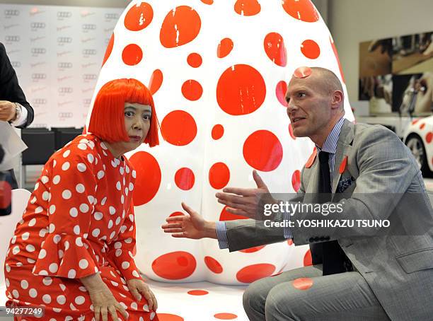 Japanese contemporary artist Yayoi Kusama and Audi Japan president Dominique Boesch pose next to one of her art designs using a large pumpkin at an...