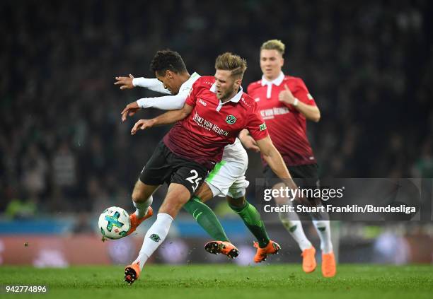 Theodor Gebre Selassie of Bremen is challenged by Niclas Fllkrug of Hannover during the Bundesliga match between Hannover 96 and SV Werder Bremen at...