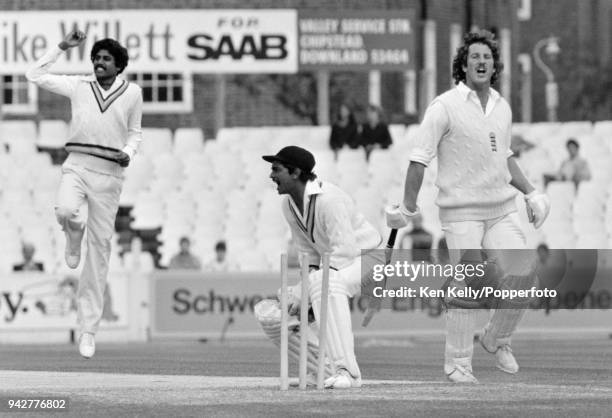Ian Botham of England is run out for 0 by India's wicketkeeper Bharath Reddy as Kapil Dev of India celebrates during the 4th Test match between...